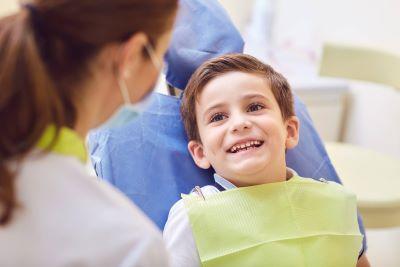 boy smiling in exam chair | children's dentist cheshire ct