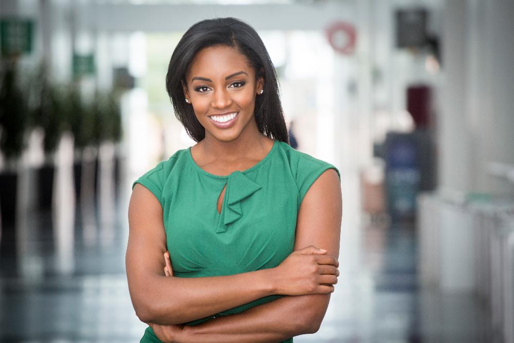 woman in green shirt smiling | teeth whitening cheshire ct