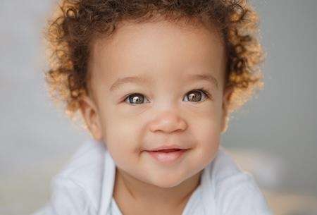 baby with curly hair smiling | children's dentist cheshire ct