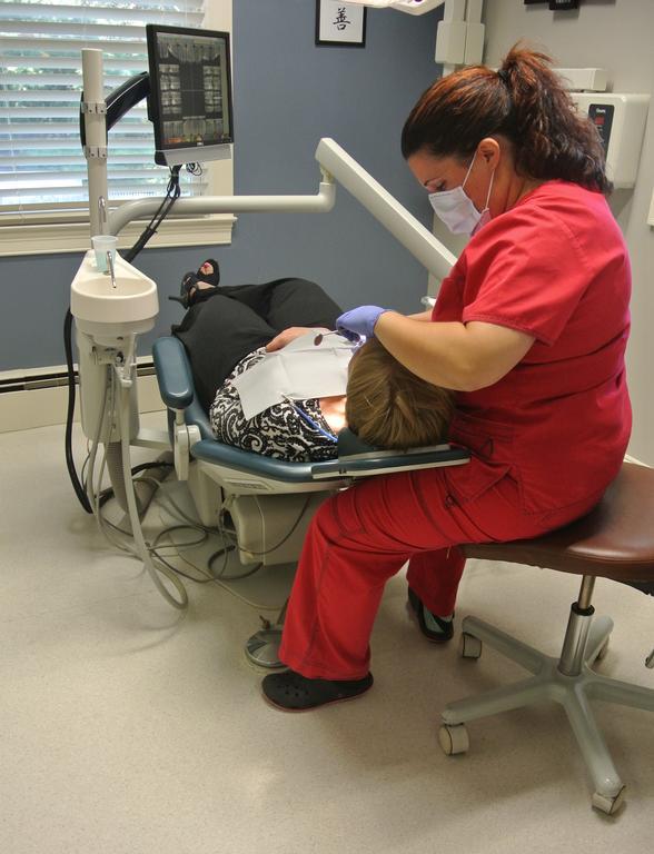 dental staff treating a patient | cheshire dental associates